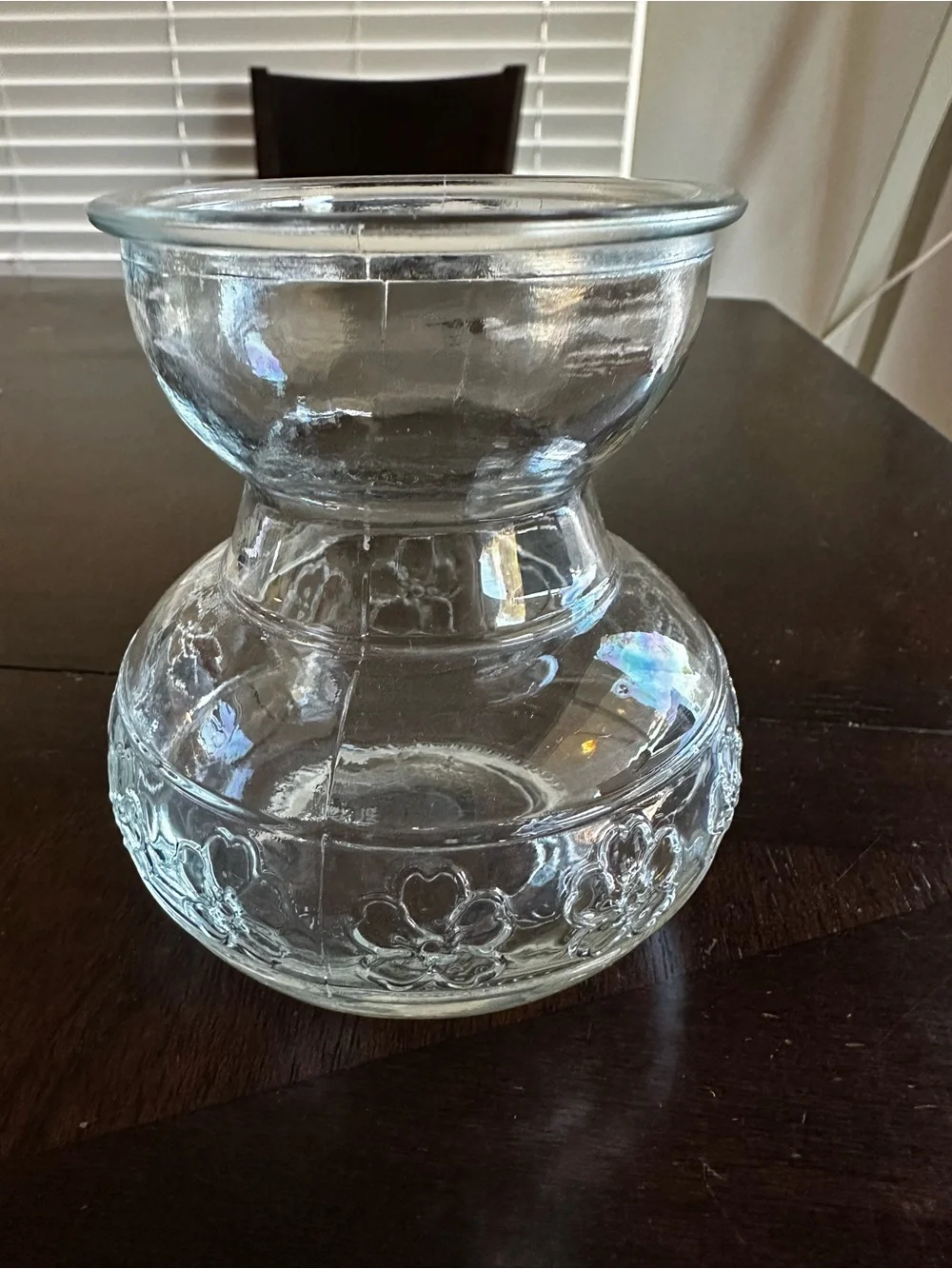 Clear glass bulb forcing vase embossed floral pattern around the base